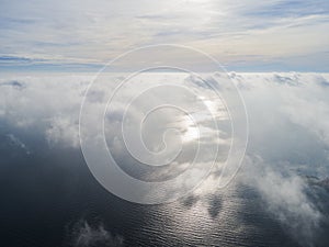 Aerial view of a Sunset sky background. Aerial Dramatic gold sunset sky with evening sky clouds over the sea. Stunning sky clouds