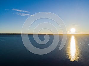 Aerial view of a Sunset sky background. Aerial Dramatic gold sunset sky with evening sky clouds over the sea. Stunning sky clouds