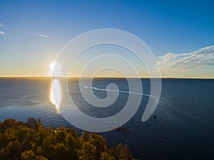 Aerial view of a Sunset sky background. Aerial Dramatic gold sunset sky with evening sky clouds over the sea. Stunning sky clouds