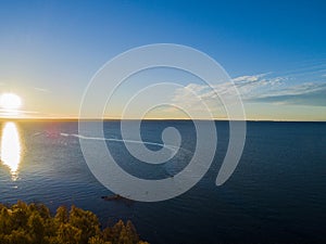 Aerial view of a Sunset sky background. Aerial Dramatic gold sunset sky with evening sky clouds over the sea. Stunning sky clouds