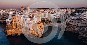 Aerial view of a sunset sky over the skyline of Polignano a Mare, Puglia, Italy photo