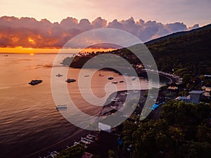 Aerial view of sunset or sunrise and quiet ocean with boats in Amed, Bali photo