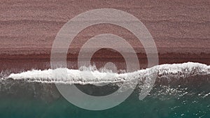 Aerial view of the sunsets over sea.Beautiful sea waves.Natural pink sand and amazing sea.Summer sunset seascape