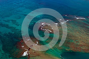 Aerial view of surf and shoals in the Pacific Ocean