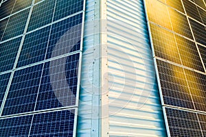 Aerial view of surface of blue photovoltaic solar panels mounted on building roof for producing clean ecological electricity.