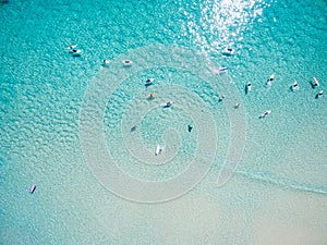 An aerial view of surfers at the beach