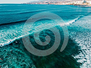 Aerial view surfers in crystal clear water, Tenerife Canary islands
