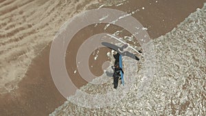 Aerial view of surfers greet each other