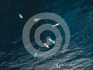 Aerial view of surfers in ocean. Surfing in ocean