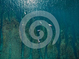 Aerial view of surfers in sea. Surfing in ocean. Top view