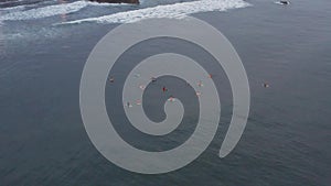 An aerial view of surfers waiting for a wave in the ocean on a clear day. Aerial view of surfer on huge Indian ocean