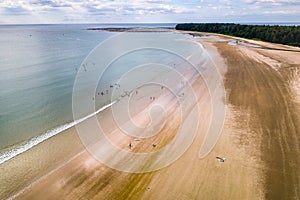 Aerial view of surfers waiting for waves off a tropical beach (Memories Beach, Khao Lak, Thailand