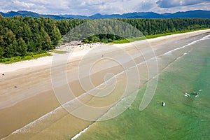 Aerial view of surfers waiting for waves off a tropical beach (Memories Beach, Khao Lak, Thailand