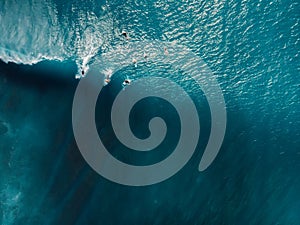 Aerial view of surfing at perfect barrel waves. Blue waves and surfers in ocean