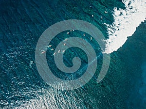 Aerial view with surfing on wave. Perfect waves with surfers in clear ocean