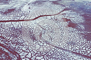 Aerial view of surrealistic industrial place. Dry surface. Desertic landscape. Human impact on the environment. View from above. photo