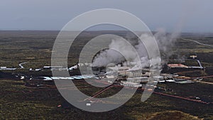 Aerial view of Svartsengi geothermal power plant with pipelines for hot water and steaming stacks near Grindavik, Iceland.