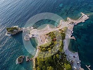 Aerial view of Sveti Nikola, Budva island, Montenegro. Hawaii beach, umbrellas and bathers and crystal clear waters. Jagged coasts