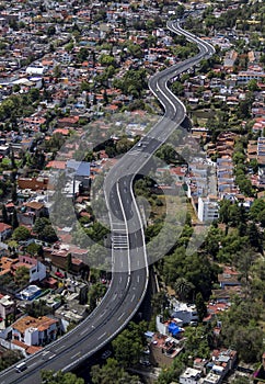 Aerial view of swaying road between houses