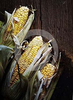 Aerial view of sweetcorn cob on wooden background
