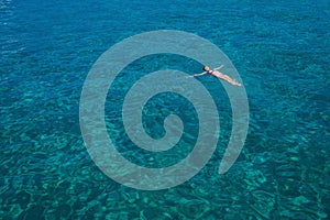 Aerial view of swimming beautiful woman in Blue Lagoon.