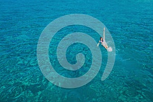 Aerial view of swimming beautiful woman in Blue Lagoon.