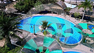 Aerial view of a swimming pool at a resort in Nha Trang, Vietnam. Romantic beach from top concept video with beach