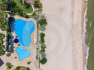 Aerial view of swimming pool with sea and beach