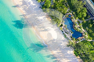 Aerial view of swimming pool with sea and beach in luxury hotel and resort for travel and vacation