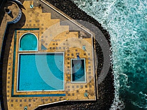 Aerial view from swimming pools near a beach. Drone shot.