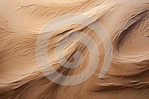 Aerial view of swirling sand patterns in a warm desert