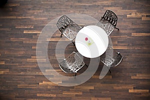 Aerial view of a table and four chairs in a cafeteria.