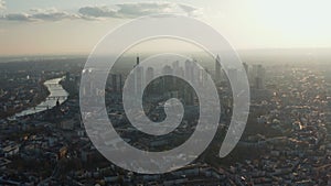 Aerial view of tall modern buildings downtown. Cityscape with skyscrapers at river winding through city. Frankfurt am