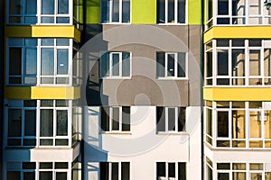 Aerial view of a tall residential apartment building with many windows and balconies