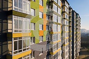 Aerial view of a tall residential apartment building with many windows and balconies