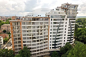 Aerial view of tall residential apartment building under construction. Real estate development