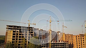 Aerial view of tall residential apartment buildings under construction.