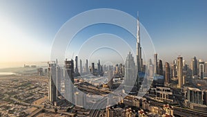 Aerial view of tallest towers in Dubai Downtown skyline and highway timelapse.