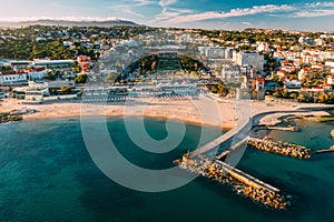 Aerial view of Tamariz Beach with Casino Estoril in the end of the garden and Hotel Palacio on