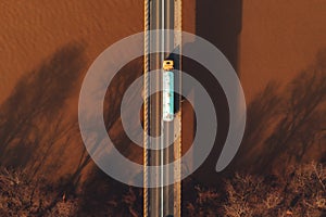 Aerial view of tank truck on bridge crossing the river