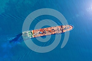 Aerial view tanker ship with liquid bulk cargo is sailing in blue water.