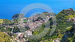 Aerial view of Taormina, on right is Castello Saraceno, in center is Ancient Greek theatre. Taormina located on Sicily island in