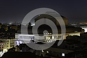 Aerial view of the Teatro Real in Madrid at night, surrounded by illuminated buildings photo