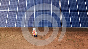 Technician checking the panel in solar power station panels