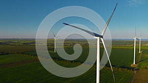 Aerial view of technological wind towers operating. Windmills producing power.