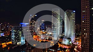 Aerial view on Tel-Aviv. Urban night city never stops. Luxury building and tall business towers