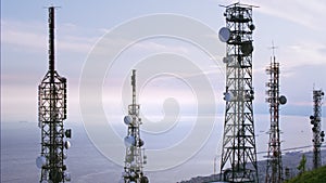 Aerial view of telecommunications towers antennas and cityscape in the background