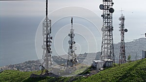 Aerial view of telecommunications towers antennas and cityscape in the background