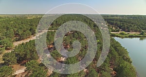 Aerial view of temperate coniferous forest and lake nearby in Bessarabia