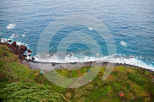 Aerial view of terrace fields and huts on the Northern Atlantic ocean coast of Madeira, Portugal